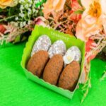 A box of three cookies on top of a table.