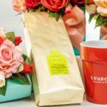 A cup and some flowers on the table