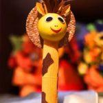 A giraffe pen with some leaves on it's head