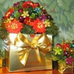 A gold box with flowers and berries in it