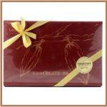 A box of chocolates with gold ribbon and bow.