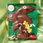 A chocolate bunny with flowers and leaves in it.
