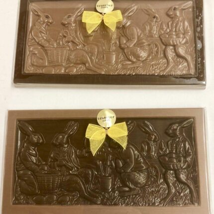 Two chocolate plaques with bows on them.