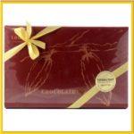 A box of chocolates with a yellow ribbon.