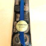 A box of chocolates with a blue ribbon.