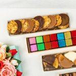 A table topped with boxes of cookies and chocolates.