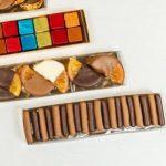 A variety of different types of cookies in boxes.