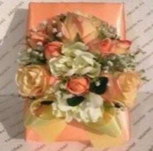 A gift box with flowers on top of it.