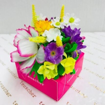 A pink box with flowers inside of it