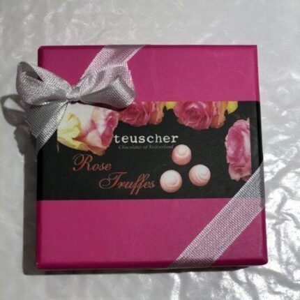 A pink box with silver ribbon and flowers