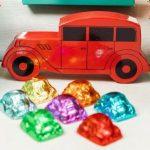 A red car and some colorful candy on the table