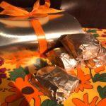 A gift box with two wrapped in tin foil.