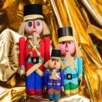 A group of three nutcrackers sitting on top of gold foil.