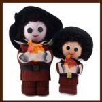 A couple of dolls that are standing up