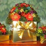 A gold box with flowers and grapes in it