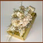 A box with flowers and ribbons on it.