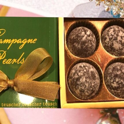 A box of champagne pearls and four truffles.