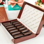 A box of chocolates sitting on top of a table.