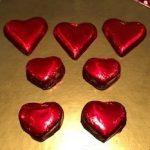 A group of red hearts sitting on top of a table.