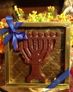 A chocolate menorah is displayed in a box.