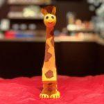 A giraffe figurine sitting on top of a red table.