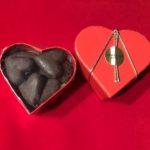 A heart shaped box with chocolate in it