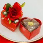 A red box with a flower on top of it.