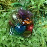 A bag of candy sitting on top of green grass.