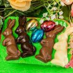 A green tray with chocolate bunnies and eggs.