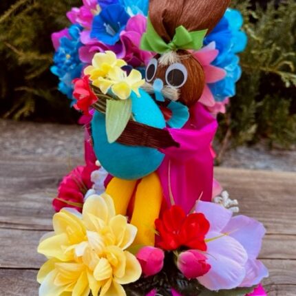 A colorful tiki doll with flowers in it.