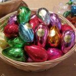 A basket of chocolate eggs sitting on top of a table.