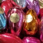 A pile of foil wrapped chocolate eggs.