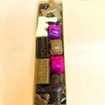 A box of chocolates in different colors and shapes.