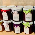 A table with many jars of honey on it