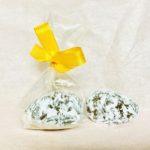 A bag of cookies with a yellow bow on top.