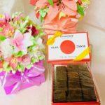 A box of brownies and flowers on the table