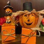 Two orange boxes with a pumpkin and scarecrow on them.