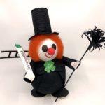 A clown doll with a top hat and cane.