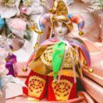 A doll with a jester hat and colorful outfit.