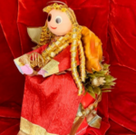 A doll with gold hair and red dress