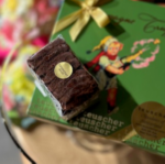 A chocolate brownie sitting on top of a book.