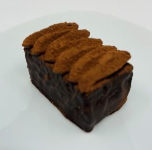 A piece of chocolate cake on top of a white plate.