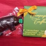 A chocolate bear with a bow on it's head.